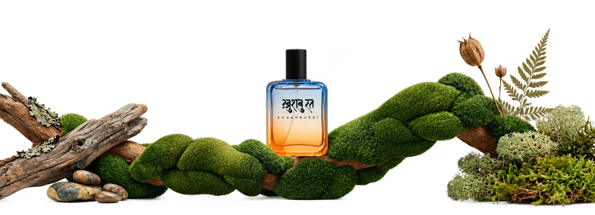 A Khushburat bottle resting on moss, driftwood and ferns